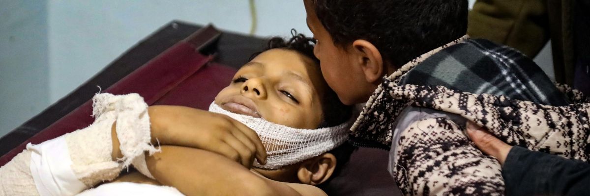 A Yemeni boy kisses the forehead of a killed youngster