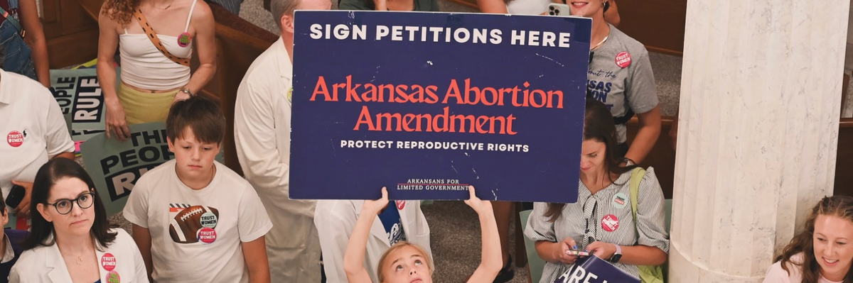 A young demonstrator holds a sign
