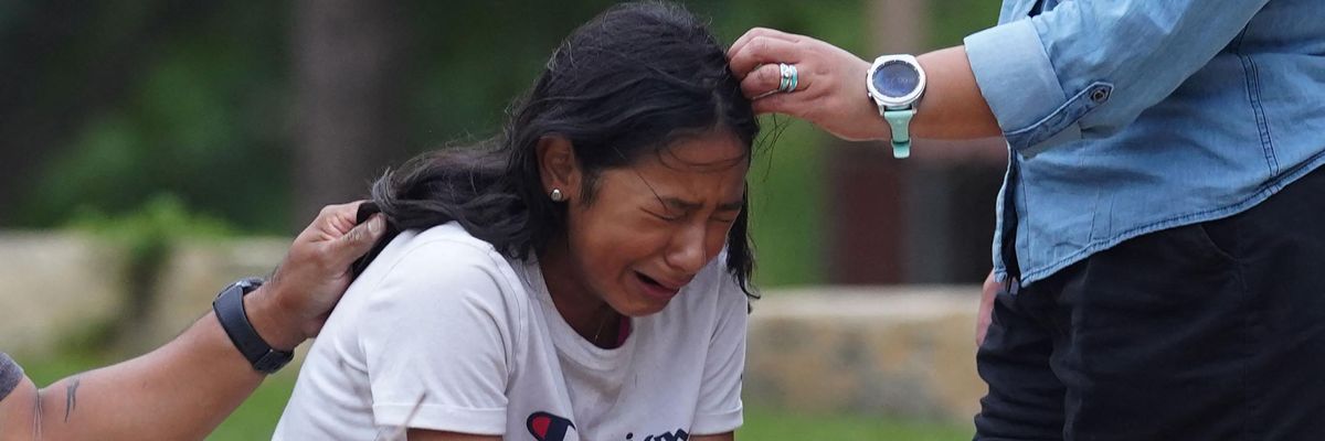 A young girl cries outside the Willie de Leon Civic Center, where grief counseling will be offered after 19 students and two teachers were slaughtered at Robb Elementary School in Uvalde, Texas on May 24, 2022.
