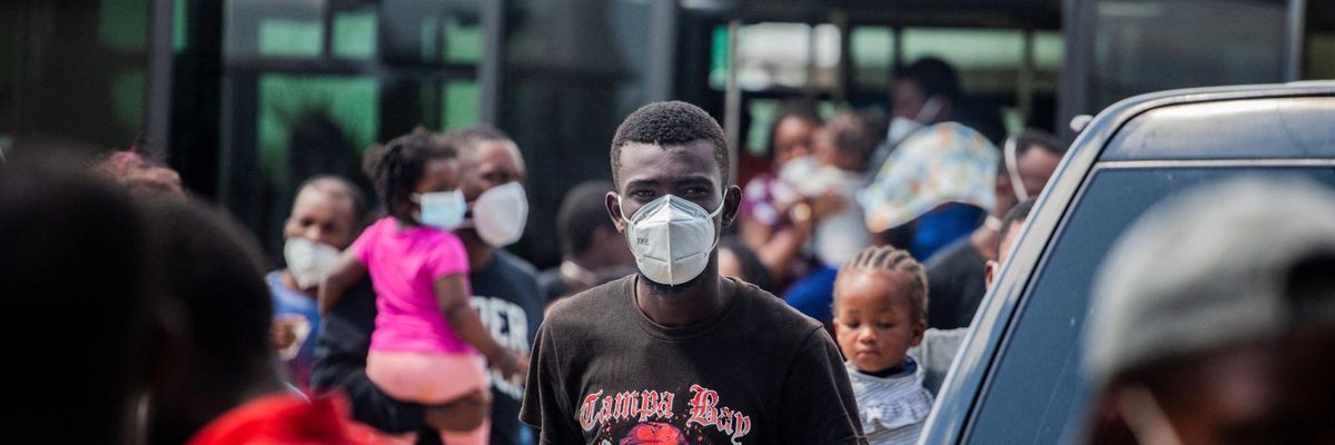 A young Haitian migrant stands in a crowd in Port-au-Prince following his deportation from the US