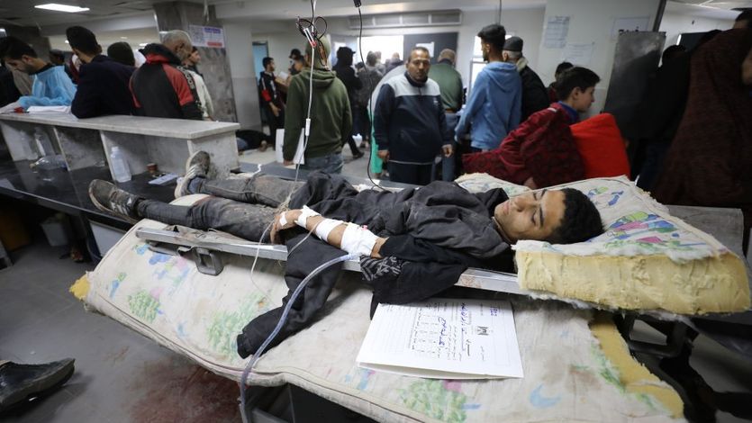 A young Palestinian manwounded in Israel's Flour Massacre lies in a hospital