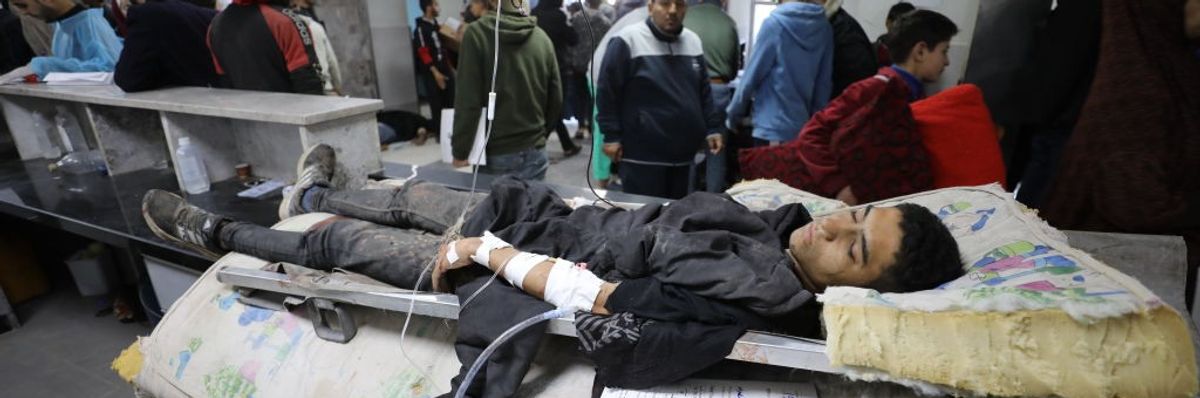 A young Palestinian manwounded in Israel's Flour Massacre lies in a hospital