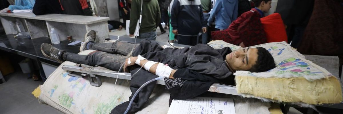 A young Palestinian manwounded in Israel's Flour Massacre lies in a hospital