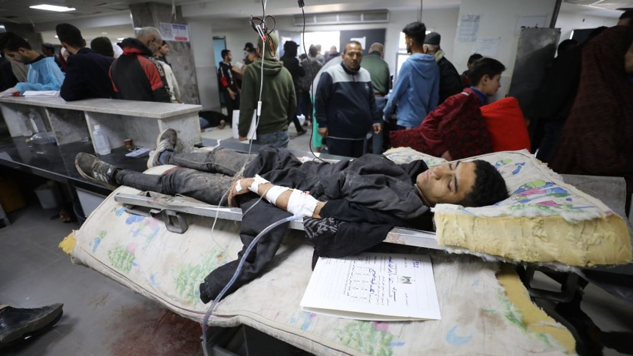 A young Palestinian manwounded in Israel's Flour Massacre lies in a hospital