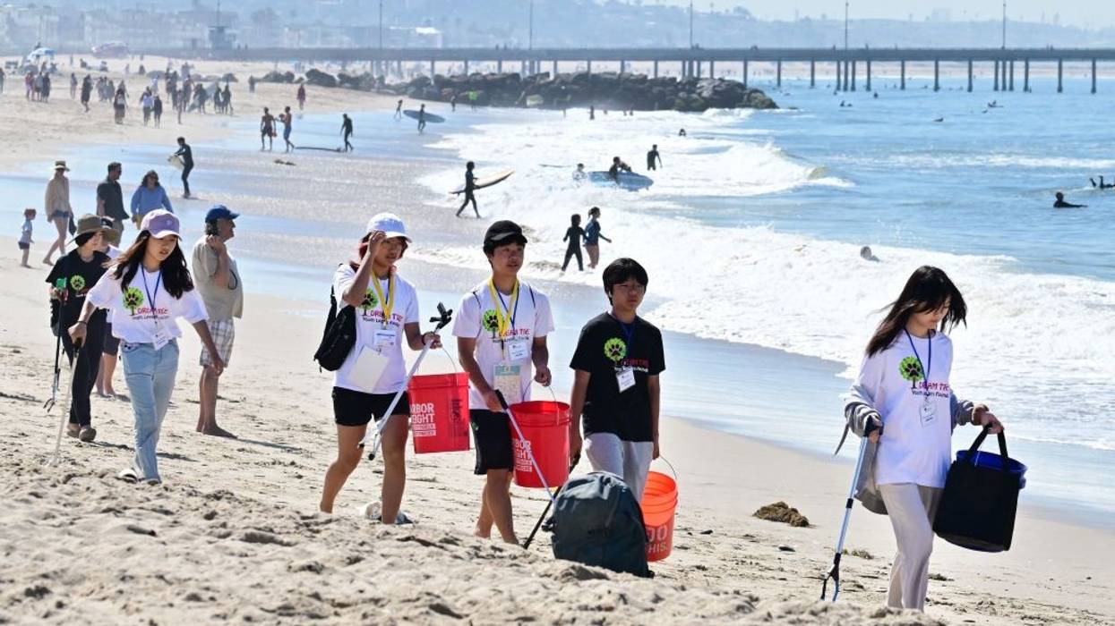 A youth group participate in cleaning up trash at Venice Beach for Earth Day on April 22, 2023, in Los Angeles, California.