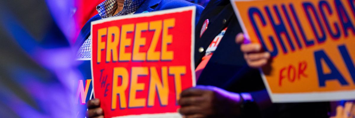 A Zohran supporter with a sign reading, 'Freeze the rent."