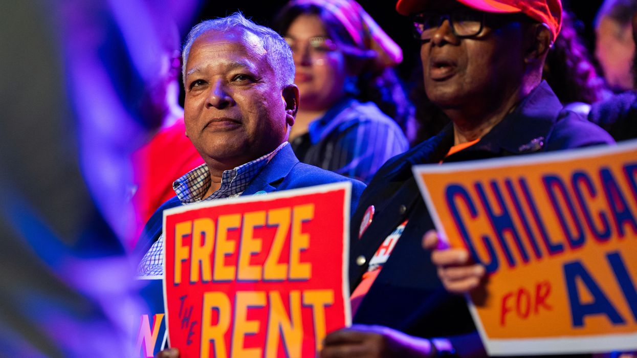 A Zohran supporter with a sign reading, 'Freeze the rent."