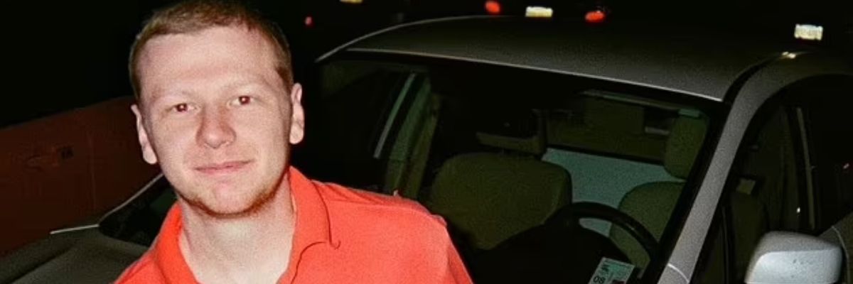 Aaron Bushnell poses for a photo in a red shirt