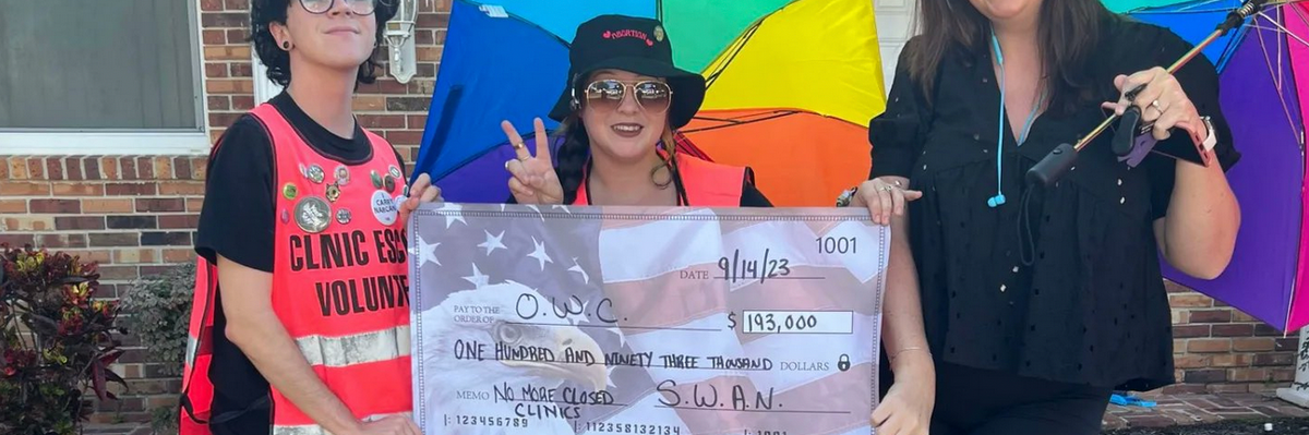 Abortion clinic escorts deliver a check for $193,000 to the Center of Orlando for Women 