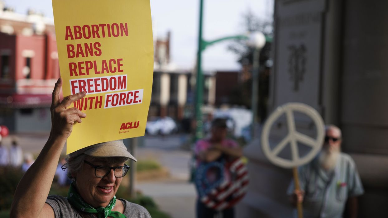 Abortion rights activist holds a placard saying, Abortion