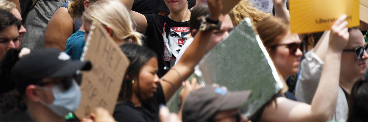 Abortion rights activists hoist their signs outside the U.S. Supreme Court in Washington, D.C. on June 24, 2022.