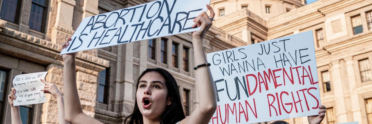 Abortion rights activists march outside the Texas State Capitol.
