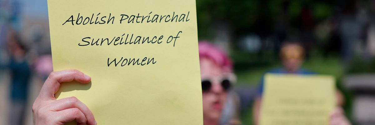 Abortion rights protest, sign readig "abolish patriarchal surveillance of women"