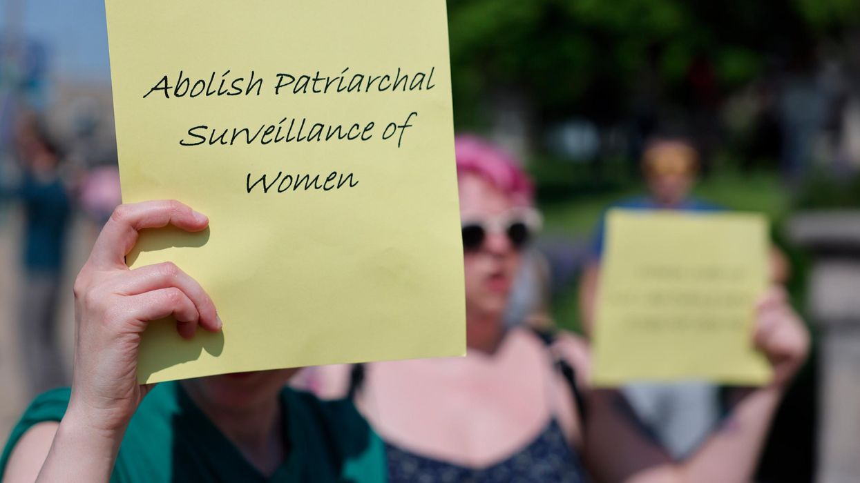 Abortion rights protest, sign readig "abolish patriarchal surveillance of women"