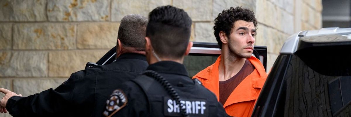 Accused killer Luigi Mangione with police