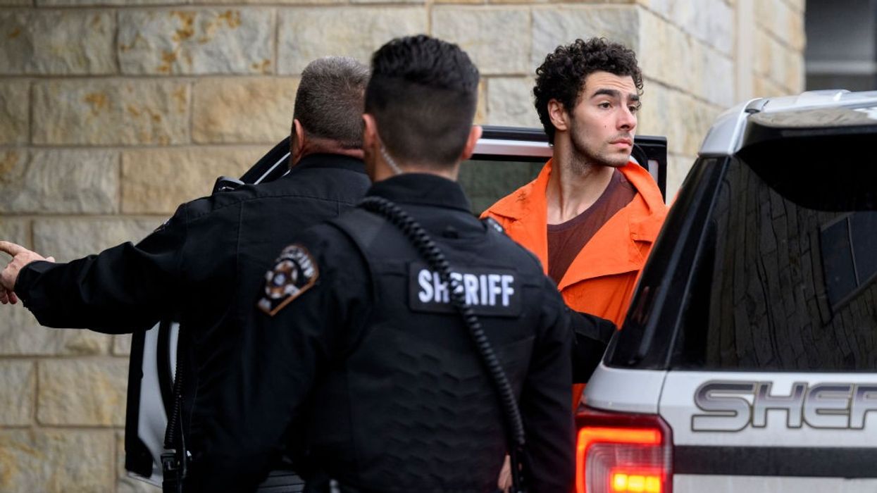 Accused killer Luigi Mangione with police