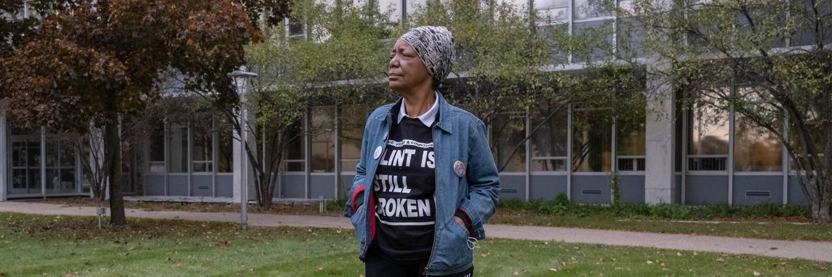Activist Claire McClinton, wearing a "Flint Is Still Broken" shirt, stands outside of City Hall in Flint, Michigan on October 20, 2020.