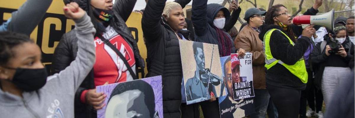 Activist Nola Darling talks on the megaphone in front of the Brooklyn Center police station at a protest over the police killing of Daunte Wright in Brooklyn Center, Minnesota, U.S., on April 13, 2021
