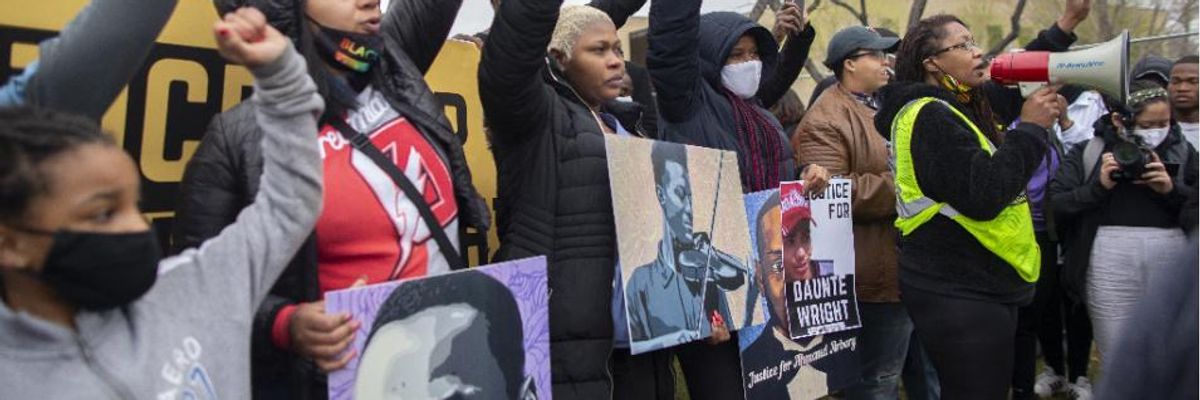 Activist Nola Darling talks on the megaphone in front of the Brooklyn Center police station at a protest over the police killing of Daunte Wright in Brooklyn Center, Minnesota, U.S., on April 13, 2021