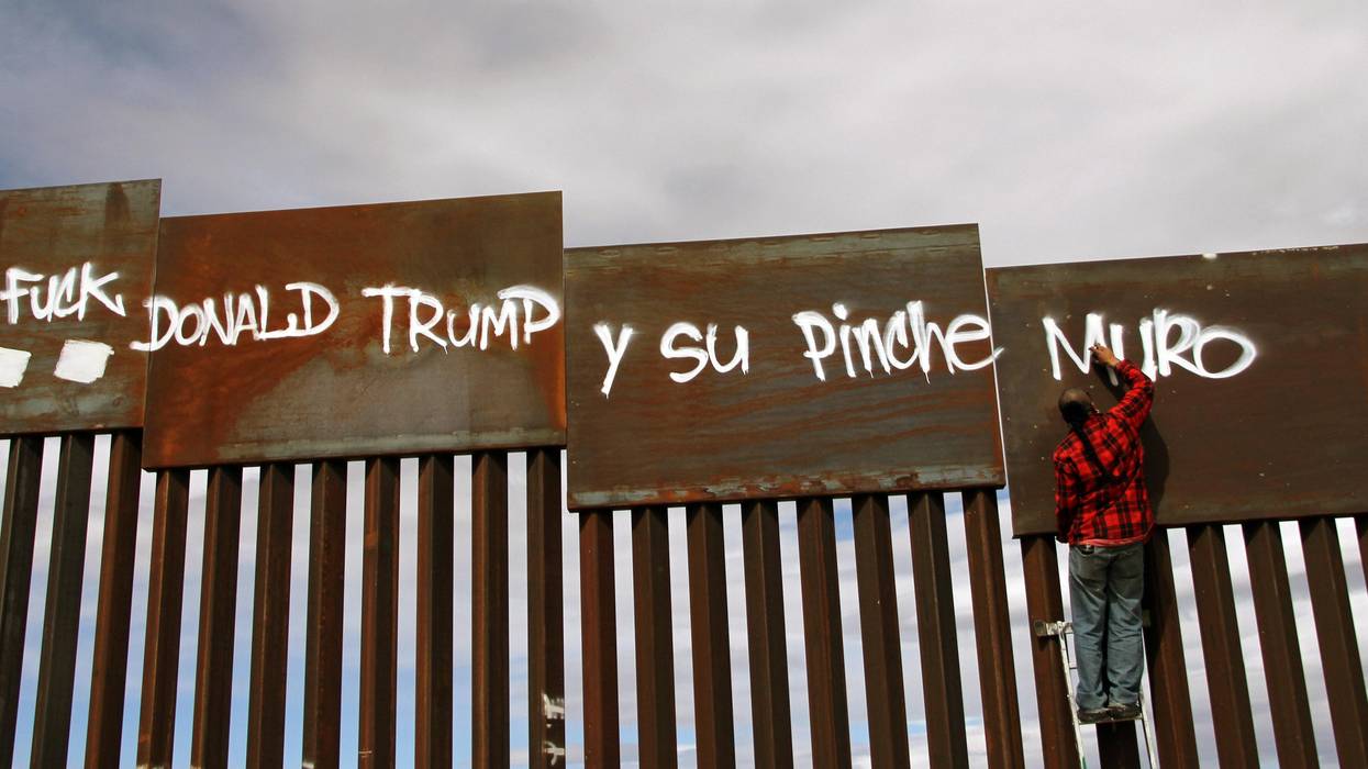 Activist paints "Fuck Donald Trump" on US border fence