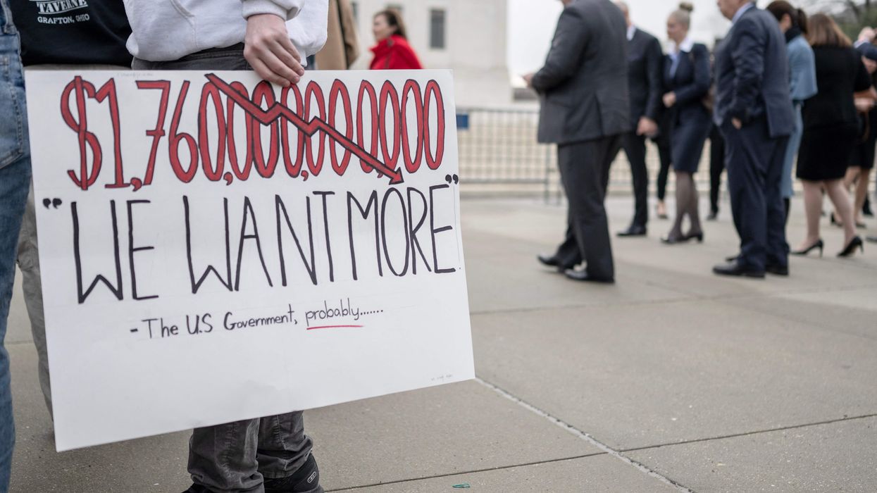 Activists and students protest in front of the Supreme Court during a rally for student debt cancellation