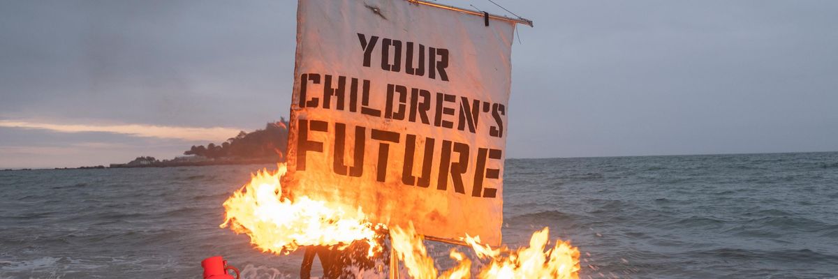 Activists burning a sail on a boat.