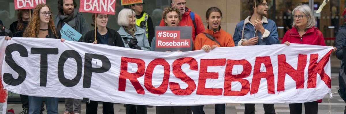 Activists carry a banner reading, "Stop Rosebank."
