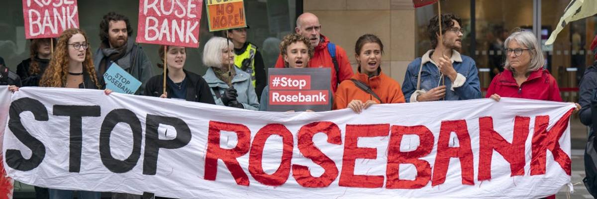 Activists carry a banner reading, "Stop Rosebank."