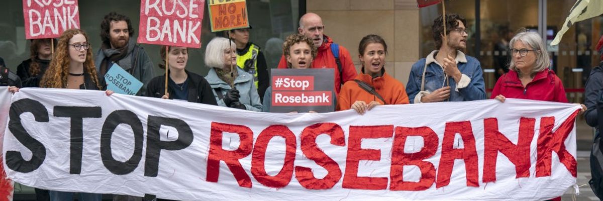 Activists carry a banner reading, "Stop Rosebank."