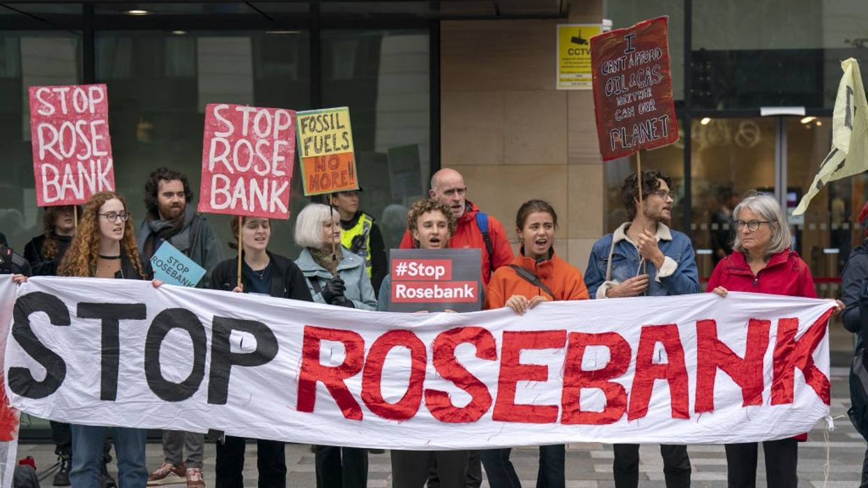 Activists carry a banner reading, "Stop Rosebank."