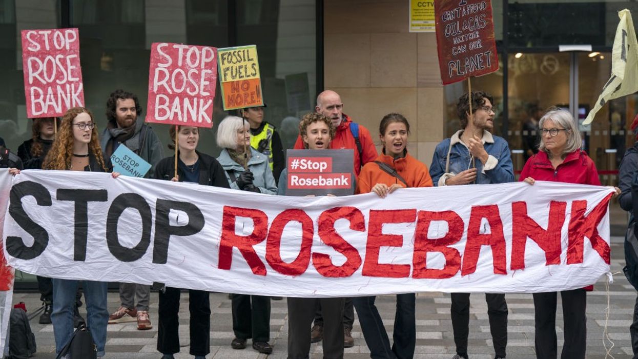 Activists carry a banner reading, "Stop Rosebank."