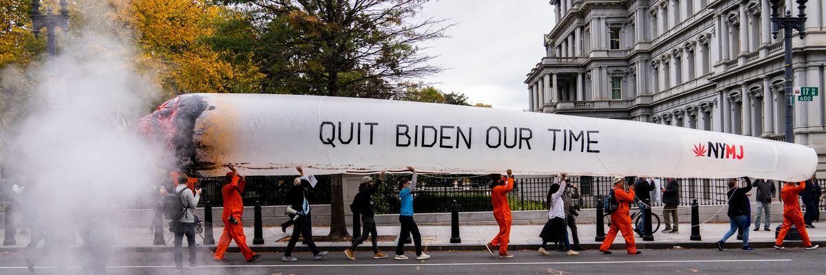 Activists carry a giant inflatable joint reading "Quit Biden Our Time" as they march in Washington.