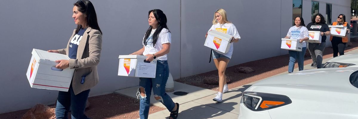Activists deliver boxes full of signatures supporting a Nevada abortion rights constitutional amendment