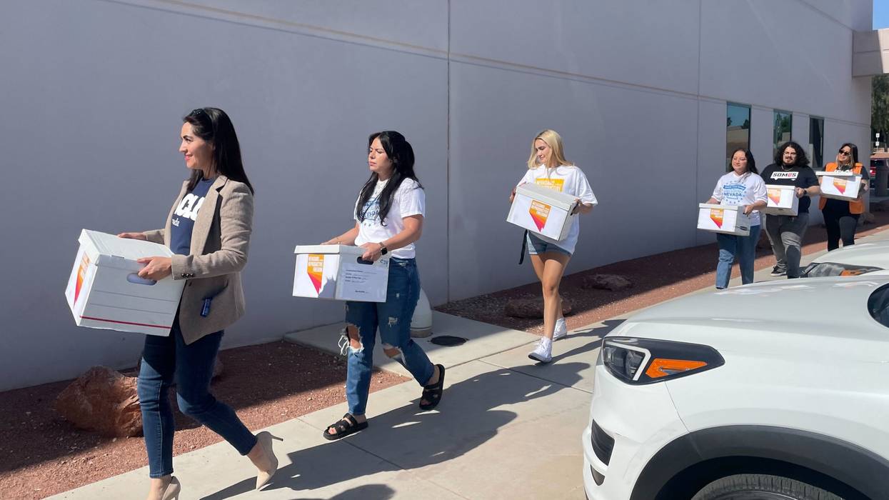 Activists deliver boxes full of signatures supporting a Nevada abortion rights constitutional amendment