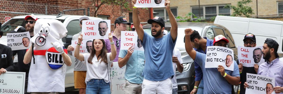 Activists demonstrate in Washington, D.C. on July 26, 2022 to urge Senate Majority Leader Chuck Schumer (D-N.Y.) to hold a vote on antitrust legislation.