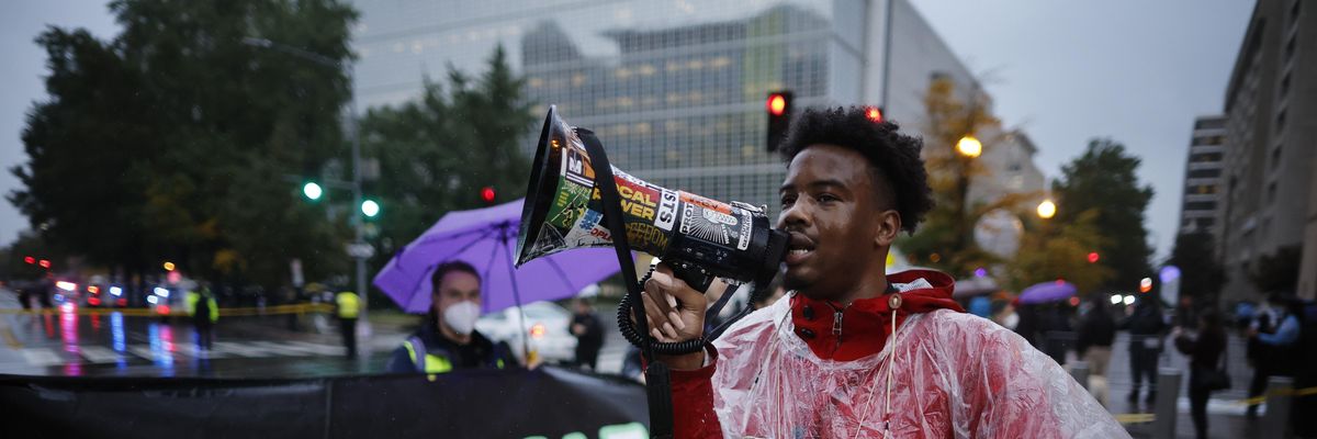 Activists from Extinction Rebellion and Debt for Climate shut down vehicle traffic in an attempt to block people from entering the annual meetings of the International Monetary Fund and the World Bank on October 13, 2022 in Washington, D.C.
