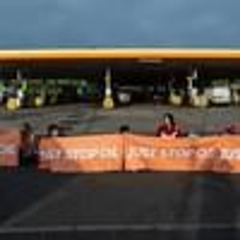 Activists from Just Stop Oil block the entrance to a Shell gas station on April 28, 2022 in Cobham, England.