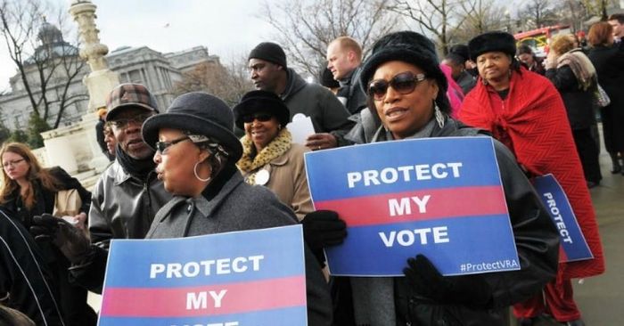 Activists hold a pro-voting rights placards outside of the U.S. Supreme Court on in Washington, D.C. (Photo: Mandel Ngan/Getty Images)
