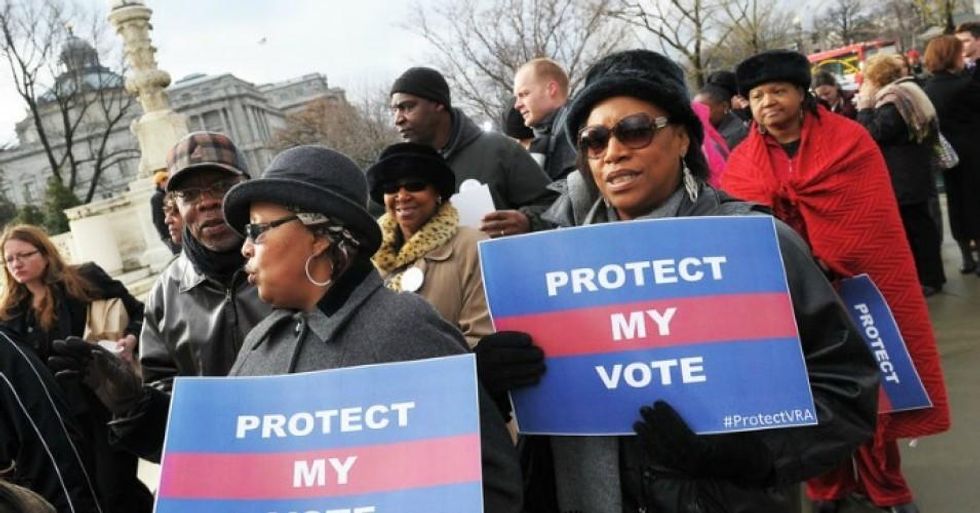 Activists hold a pro-voting rights placards outside of the U.S. Supreme Court on in Washington, D.C. (Photo: Mandel Ngan/Getty Images)