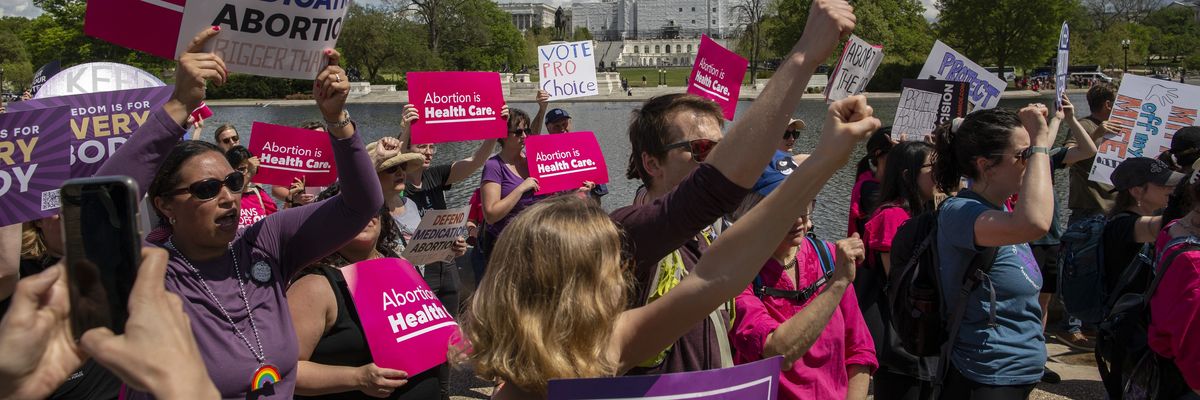 Activists hold abortion rights signs and shout slogans outside the U.S. Supreme Court in Washington, D.C. on April 15, 2023.