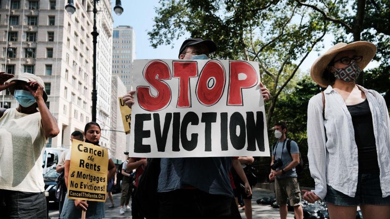 Activists hold sign that says "Stop Eviction" in New York City