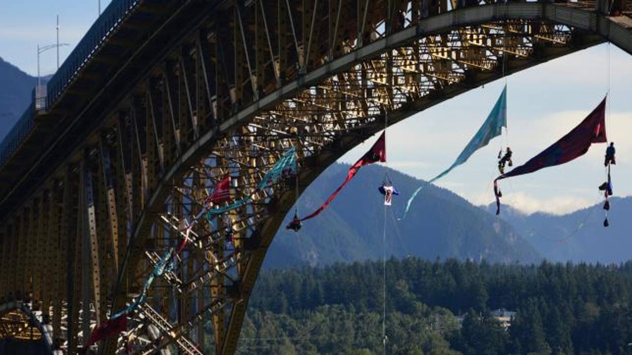 Activists launched an aerial bridge blockade in the path of a Trans Mountain tar sands oil tanker at the Ironworkers Memorial Bridge in Vancouver, British Columbia on July 3, 2018