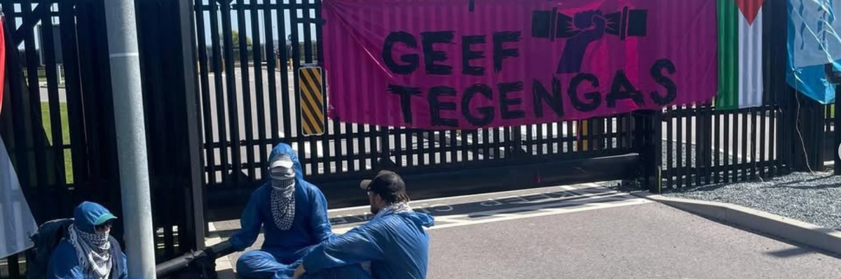 Activists lock themselves to a pole at the entrance to a Dutch Microsoft data center