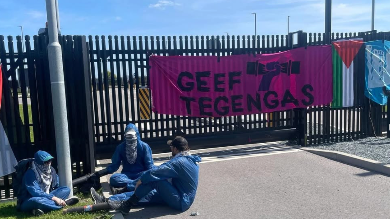 Activists lock themselves to a pole at the entrance to a Dutch Microsoft data center