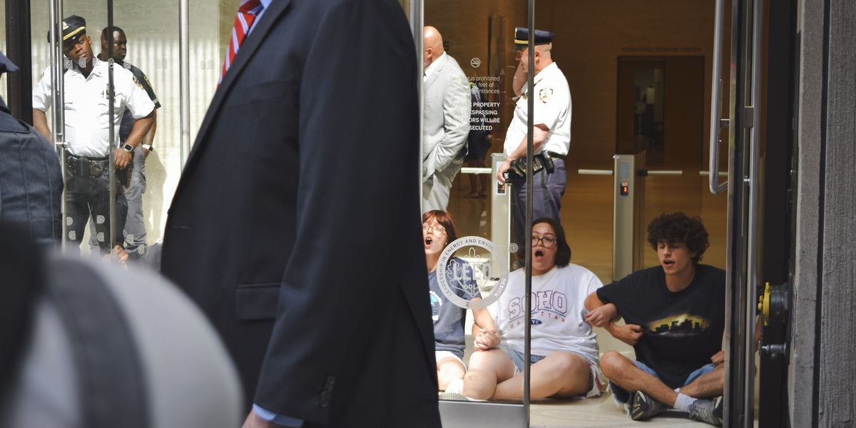 Activists locking arms inside the Chubb headquarters