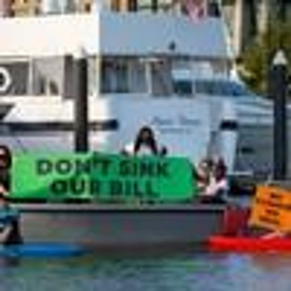 Activists near Sen. Manchin's houseboat hold 'Don't sink our bill' sign