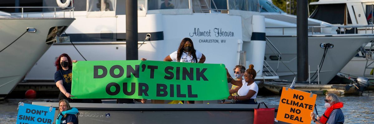 Activists near Sen. Manchin's houseboat hold 'Don't sink our bill' sign
