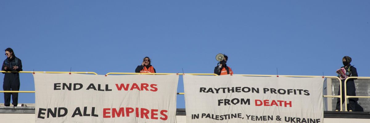 Activists occupy the roof of a Raytheon building