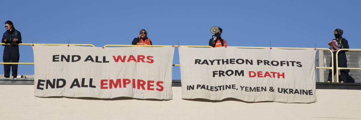 Activists occupy the roof of a Raytheon building