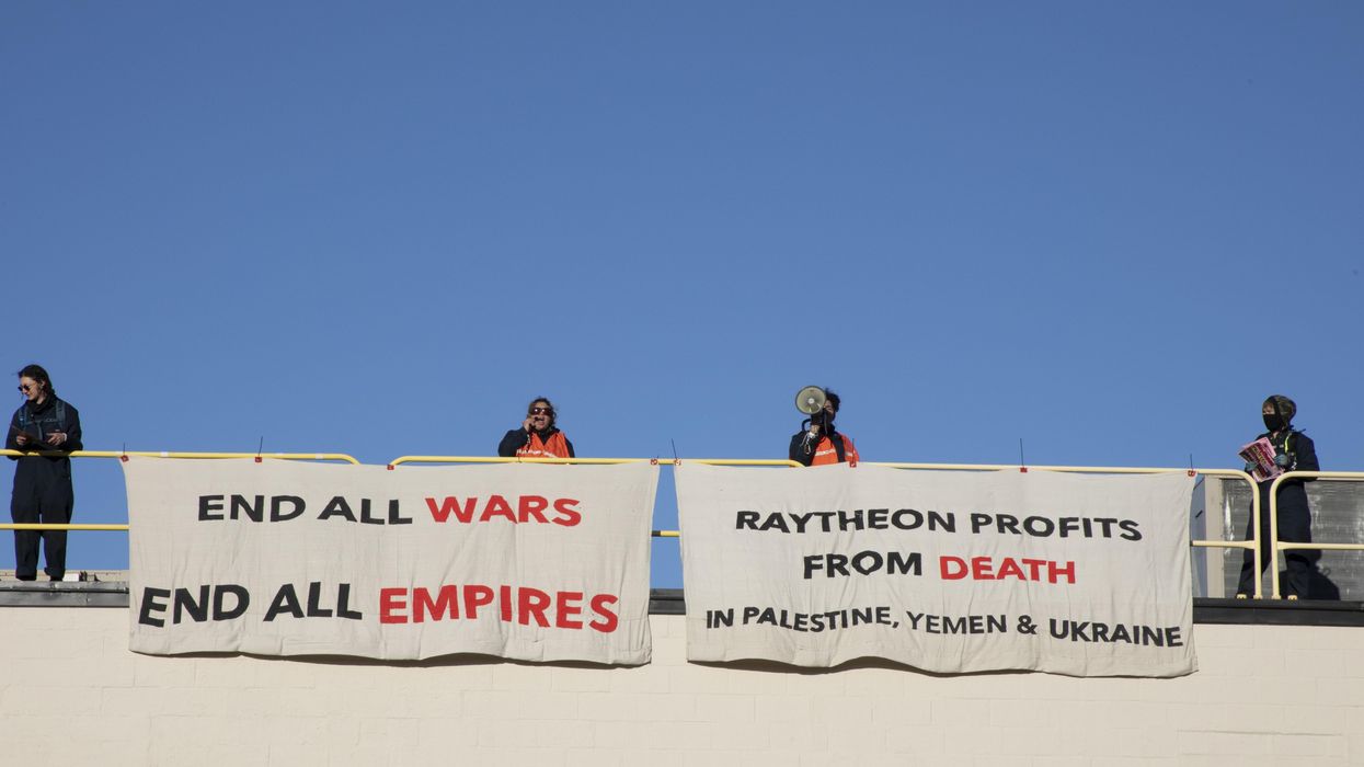 Activists occupy the roof of a Raytheon building